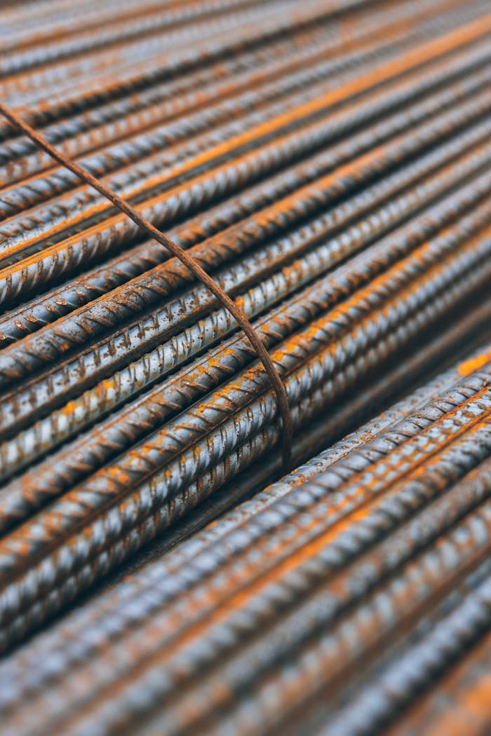 Detailed view of rusty steel rebars stacked in parallel pattern highlighting construction materials